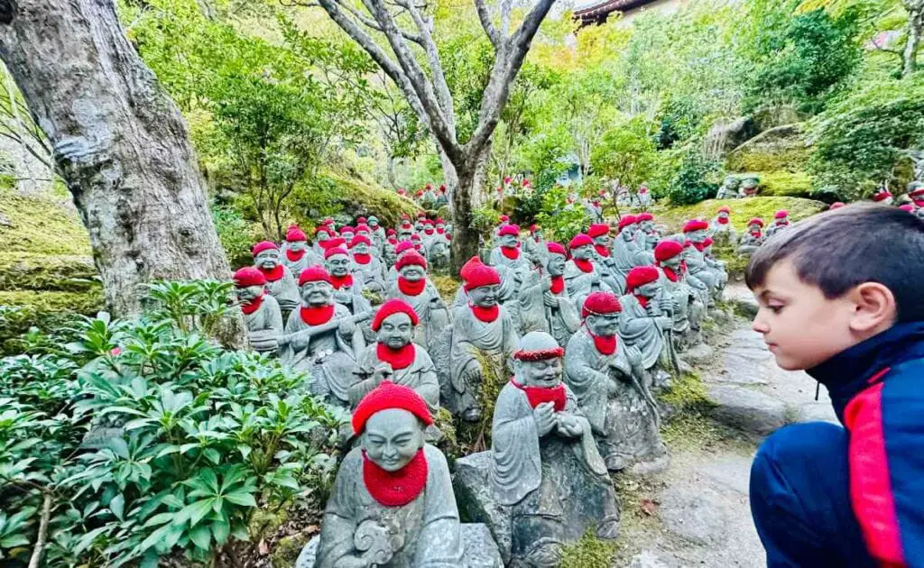 My son staring at Daisho-in Temple Statues